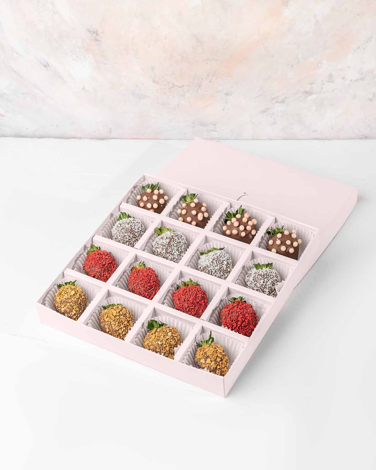 16 Chocolate Strawberries '24 Collection by NJDChocolate & ConfectioneryYour Gift Contains:• 16 x Chocolate covered strawberries• Box Size: 24x24x4cmHandling and Storage • Keep away from direct heat and sunlight• Best stored between 12-18 °C• Strawberries